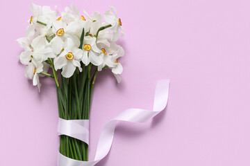 Bouquet of beautiful daffodil flowers on lilac background