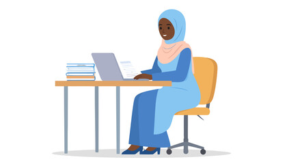 Smiling Black Muslim woman in a blue hijab and dress working on a laptop at a desk.