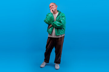Full Body Of Senior Asian Male In Green Jacket Thinking With Thoughtful Expression And Hand On Chin