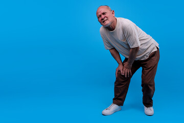 Mature Asian Man Holding His Knee Feels Joint Pain Or Discomfort