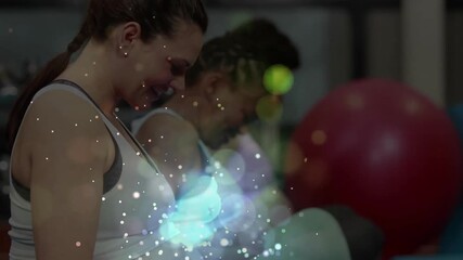 Camera zooming in on prenatal class participant curling dumbbells during fitness session, laughing - Powered by Adobe