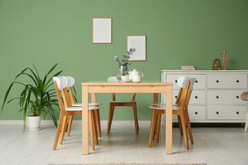 Interior of modern dining room with teapot and cups on table