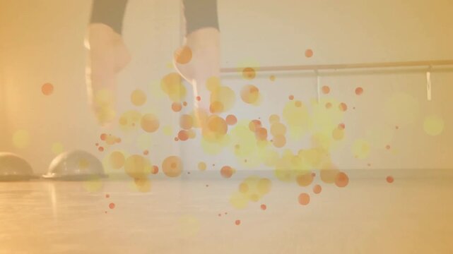 Dancer's feet sparking orange orbs, crossing lifting heels, balancing on balls making glowing halo