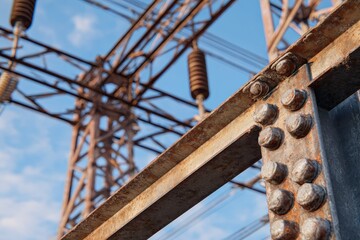 Corroded metal towers with cables built from angular sections and rivets