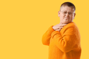 Sick little boy on yellow background