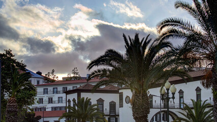 Sunset over houses and palms in Funchal, Madeira, Portugal timelapse