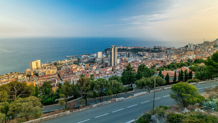 Fototapeta premium Cityscape timelapse of Monte Carlo, Monaco with roofs of buildings during summer sunset.