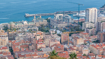 Cityscape timelapse of Monte Carlo, Monaco with roofs of buildings during summer sunset.