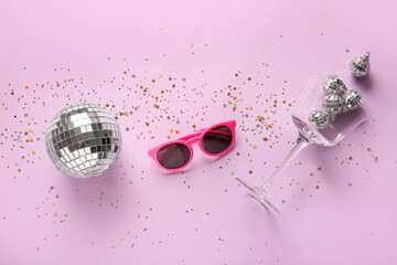 Composition with stylish sunglasses, glass, disco balls and confetti on color background