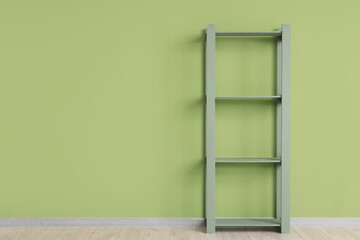 Empty bookshelf near green wall in room