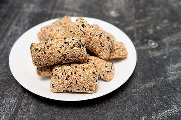 Phuket taro sesame puff pastry (Mor Lao), made from taro mixed with rice flour, sprinkled with sesame, a traditional Phuket tea snack of Thailand