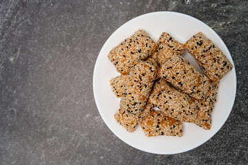 Phuket taro sesame puff pastry (Mor Lao), made from taro mixed with rice flour, sprinkled with sesame, on table top view.
