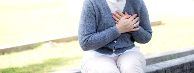 Caucasian woman chest pain in outdoor park, emergency of patient with injury, urgency and disease...