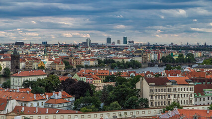 Obraz premium Panorama of Prague Old Town with red roofs timelapse, famous Charles bridge and Vltava river, Czech Republic.