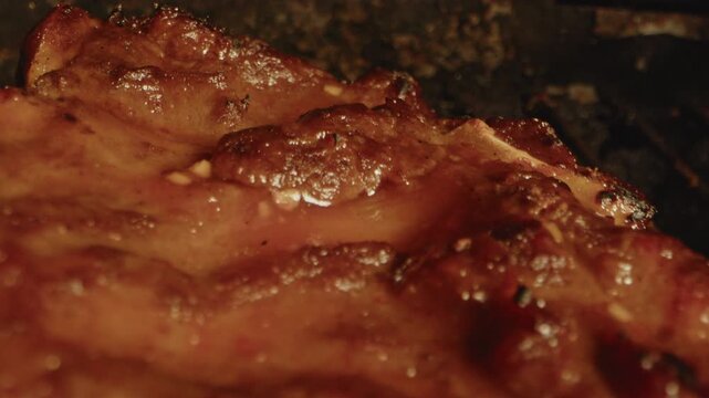 Beautiful macro dolly out of a slab of spareribs slowly being grilled on a barbecue