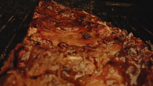 Beautiful dolly out of deliciously grilled spareribs on a dirty barbecue