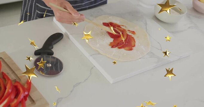 Culinary cook reaching for tomato sauce bowl, spiraling sauce across dough for pizza topping