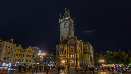 Obraz premium Prague Old Town Hall at Night timelapse hyperlapse with unrecognizable tourists walking