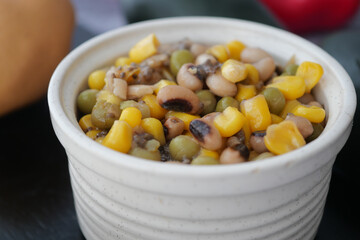 Colorful bean and corn salad served in a white bowl