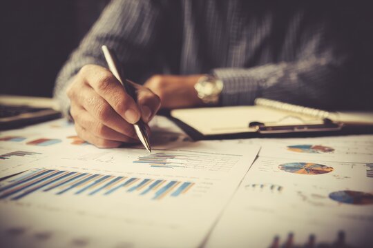 Entrepreneur assessing investment graphs with retro effects