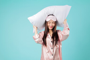 Young Asian woman in pajamas holds fluffy pillow, resting head and dreaming, feeling ready to...