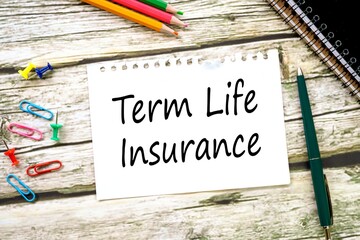 Term Life Insurance. on a torn page from a notebook on a wooden table. view from above.