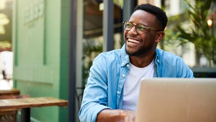 Smiling Young Man Working on Laptop Outdoors