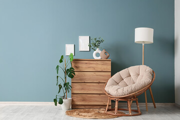 Interior of living room with cocoon chair, commode and lamp