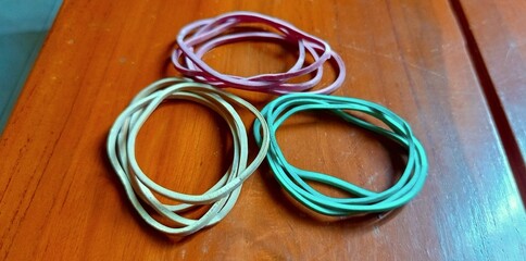 Photo of rubber bands in red, yellow, and green.