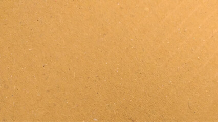 Background of brown kraft paper or cardboard texture. Abstract pattern of beige rough carton, old paper sheet, parchment.