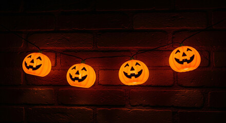 Halloween pumpkin lights glowing jack o lanterns on brick wall for spooky season decor and celebrations