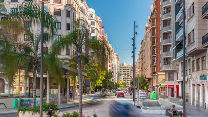 Traffic passes near a bus stop close to Valencia Central Market on avenue de l'Oest timelapse.