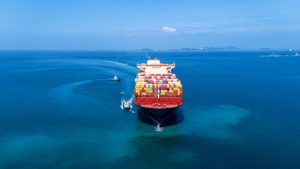 Aerial of cargo ship carrying container  for export cargo from cargo yard port to other ocean concept smart freight shipping ship front view © Yellow Boat