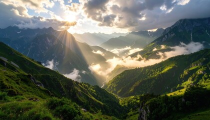 Firefly sun rays break through dramatic clouds over misty valleys in the alpine landscape creating a beautiful and serene scene.