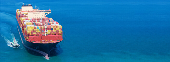 Aerial of cargo ship carrying container export cargo from cargo yard port to other ocean concept...