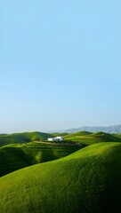 Obraz premium Modern white house nestled amongst rolling green hills under a clear blue sky
