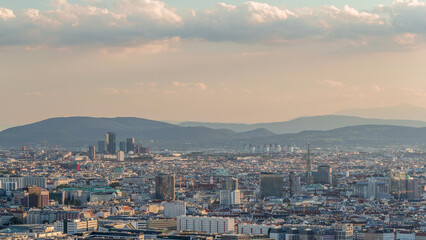Aerial panoramic view of Vienna city with skyscrapers, historic buildings and a riverside promenade timelapse in Austria.
