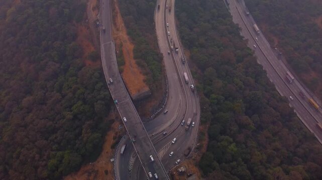 Multi lane Pune Mumbai Expressway carved through mountains, Lonavala valley, Maharashtra, Drone shot