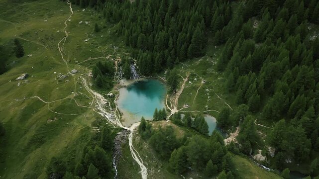 Aerial: Arolla's Blue Lake during the day in Val d'Herens, canton of Valais, Switzerland, orbit drone shot