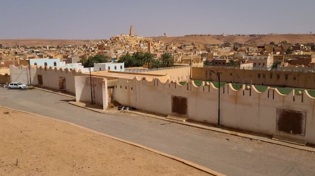 Overlooking Ghardaia in Algeria, where traditional mud-brick homes and rolling desert hills capture the unique character of this Saharan oasis town