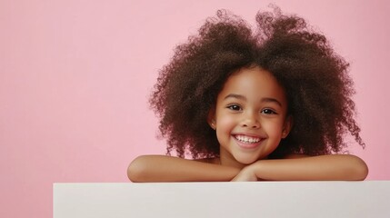Happy girl with afro hair on pink background.