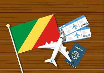 Flag off Republic of the Congo with passport and toy airplane on wooden background. Flight travel concept 