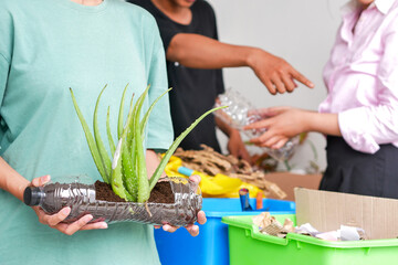 Woman Hands Holding Recycled Plastic Bottle Containing Aloe Vera Plant Showcasing Sustainable Living