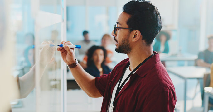 College, classroom and teacher writing on whiteboard for lesson, learning and education at school. University, lecturer and man with notes for students for knowledge, assignment and teaching course