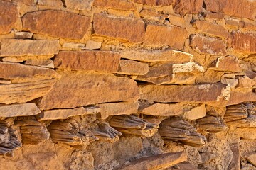 Closeup of a wall with small logs used to support a floor on the second level at Chaco Canyon Pueblo, New Mexico.
