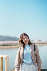 Woman tourist sightseeing Kitakami Tenshochi Park with Sakura Cherry Blossom in Spring, traveler travel in Kitakami festival, Iwate prefecture, Japan. Landmark for Travel and Vacation destination