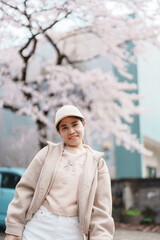 Woman tourist sightseeing Sakura Cherry Blossom in Spring. Happy traveler travel in Samurai village...