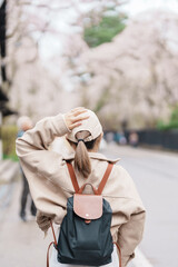 Woman tourist sightseeing Sakura Cherry Blossom in Spring. Happy traveler travel in Samurai village...