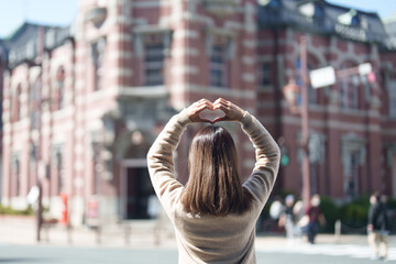 Woman tourist sightseeing at Bank of Iwate Red Brick Building, happy traveler travel in Morioka...
