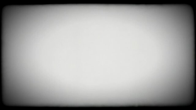 A blank, grainy, monochrome screen with dark vignette borders.